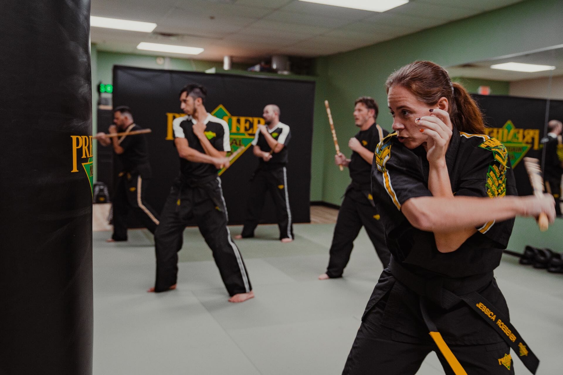 Adult Martial Arts Adults practice their technique at a Premier Martial Arts Studio