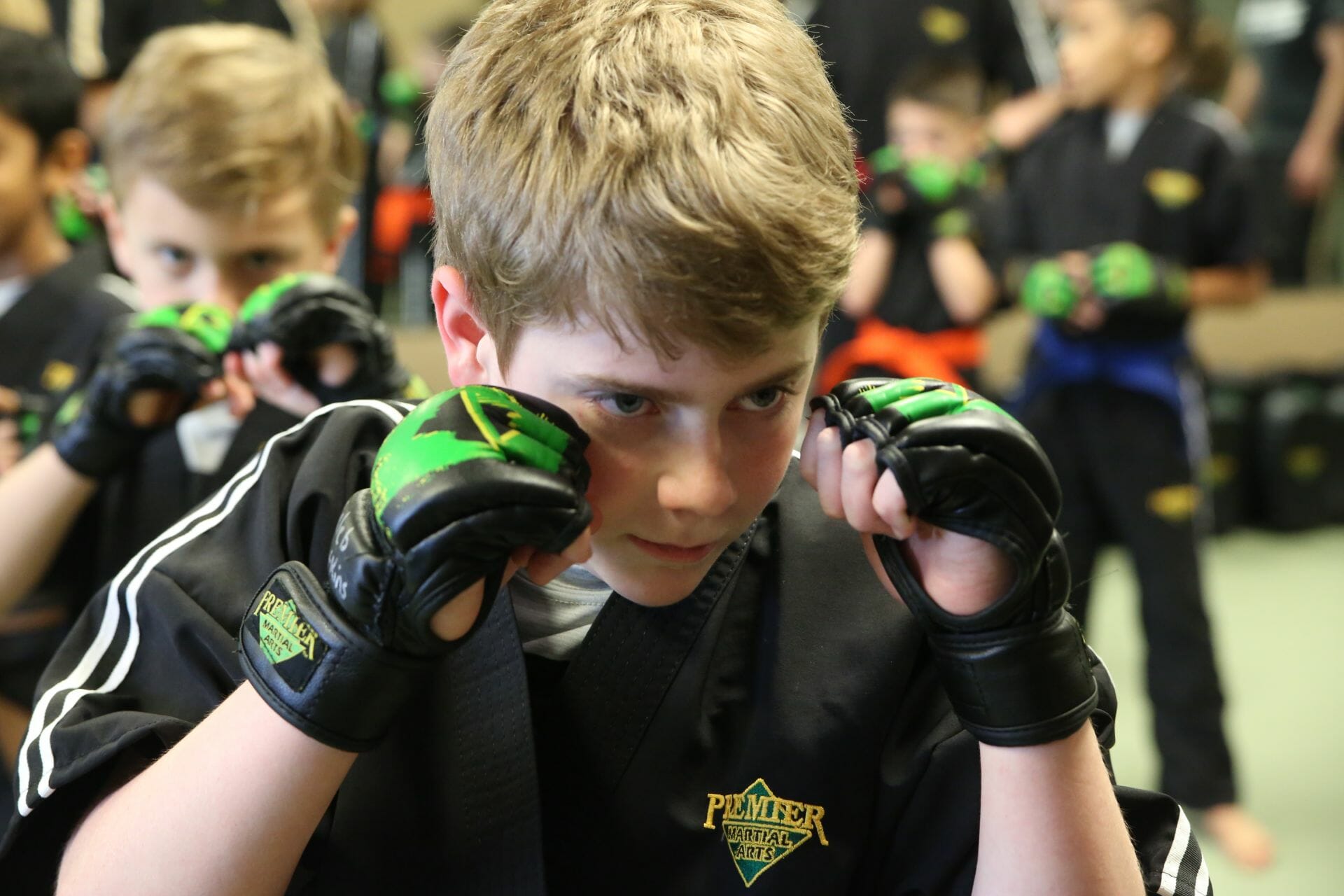 Kids Martial Arts A boy with a determined looks practices at Premier Martial Arts