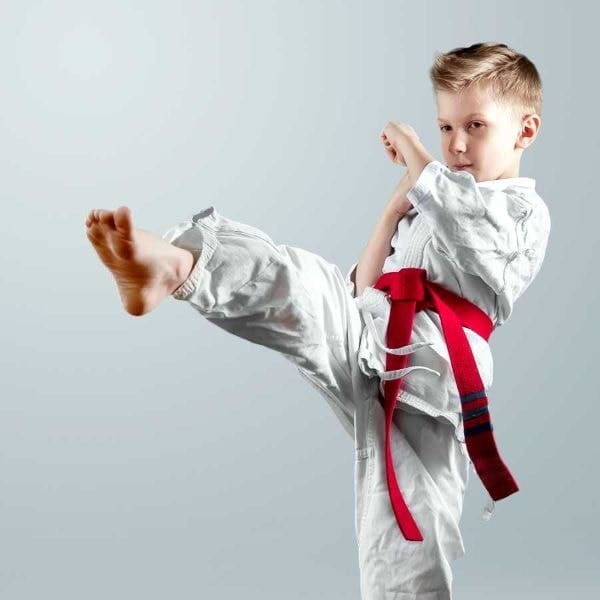 A premier martial arts student performing a front kick